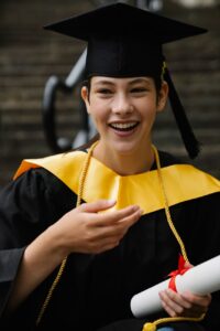 smiling woman in black academic dress